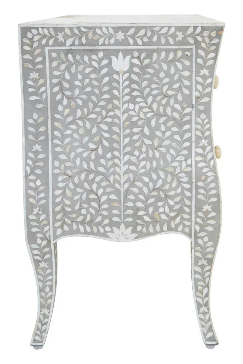 Grey bedside table with white floral bone inlay pattern and curved legs