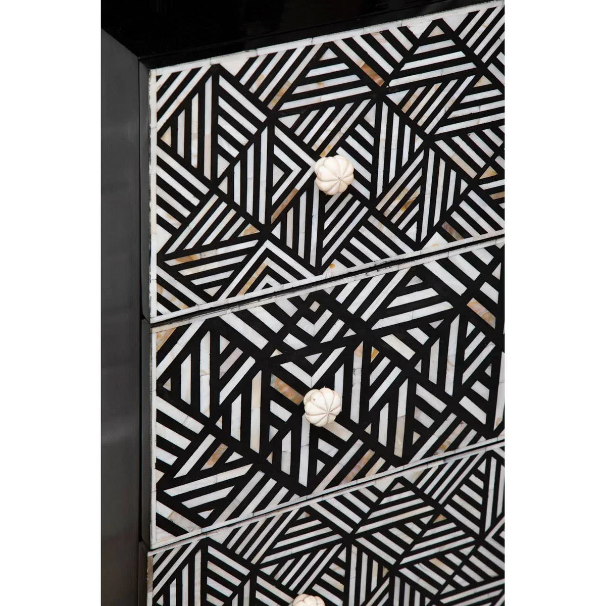 Black and white geometric chest of drawers with bone inlay detail and round knobs