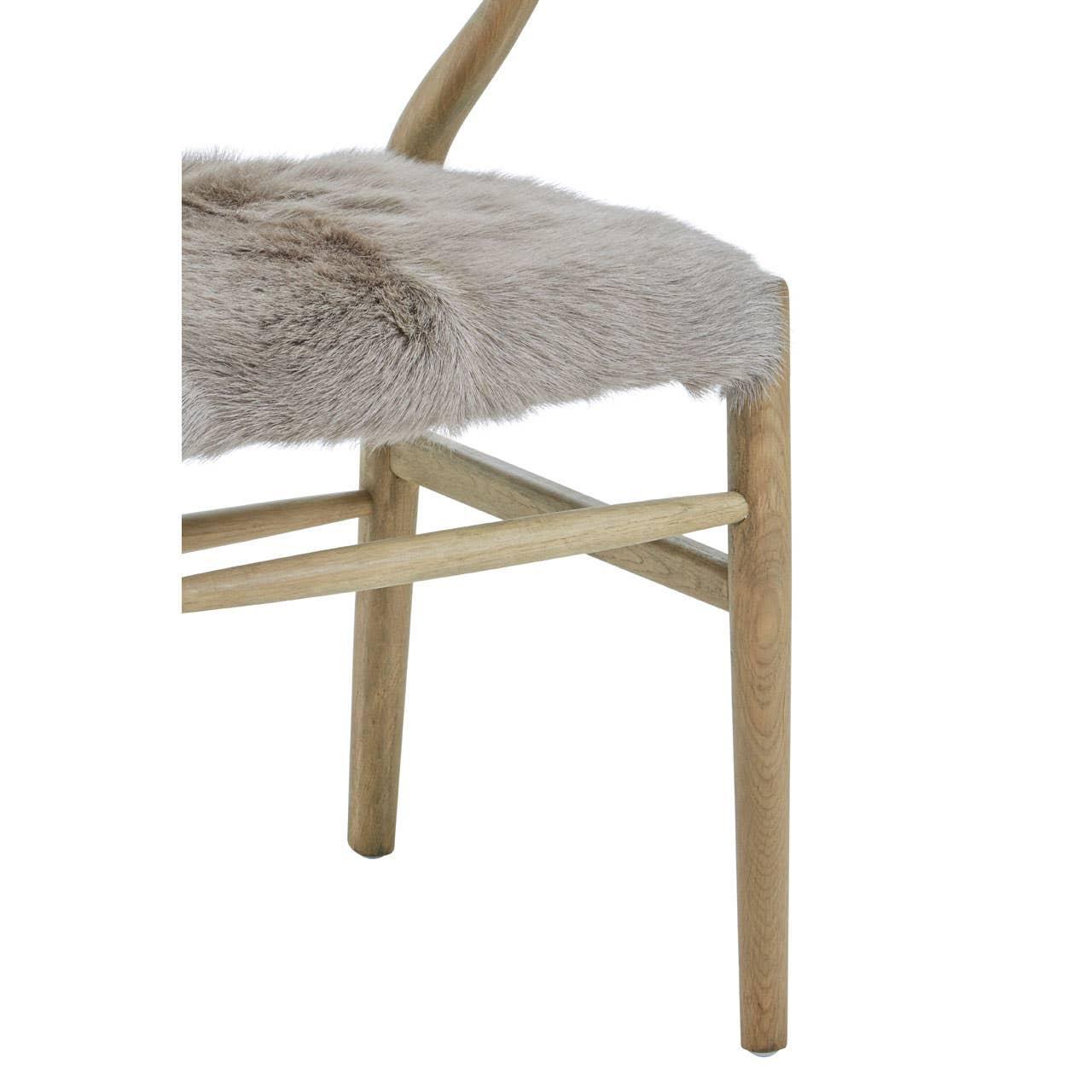Light oak chair with curved legs and grey faux fur seat cover