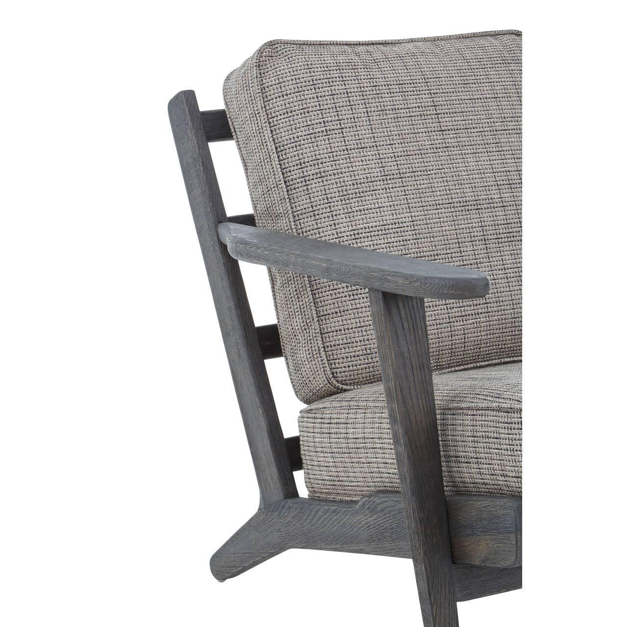 Close-up of fabric armchair with dark wooden frame and grey textured cushions