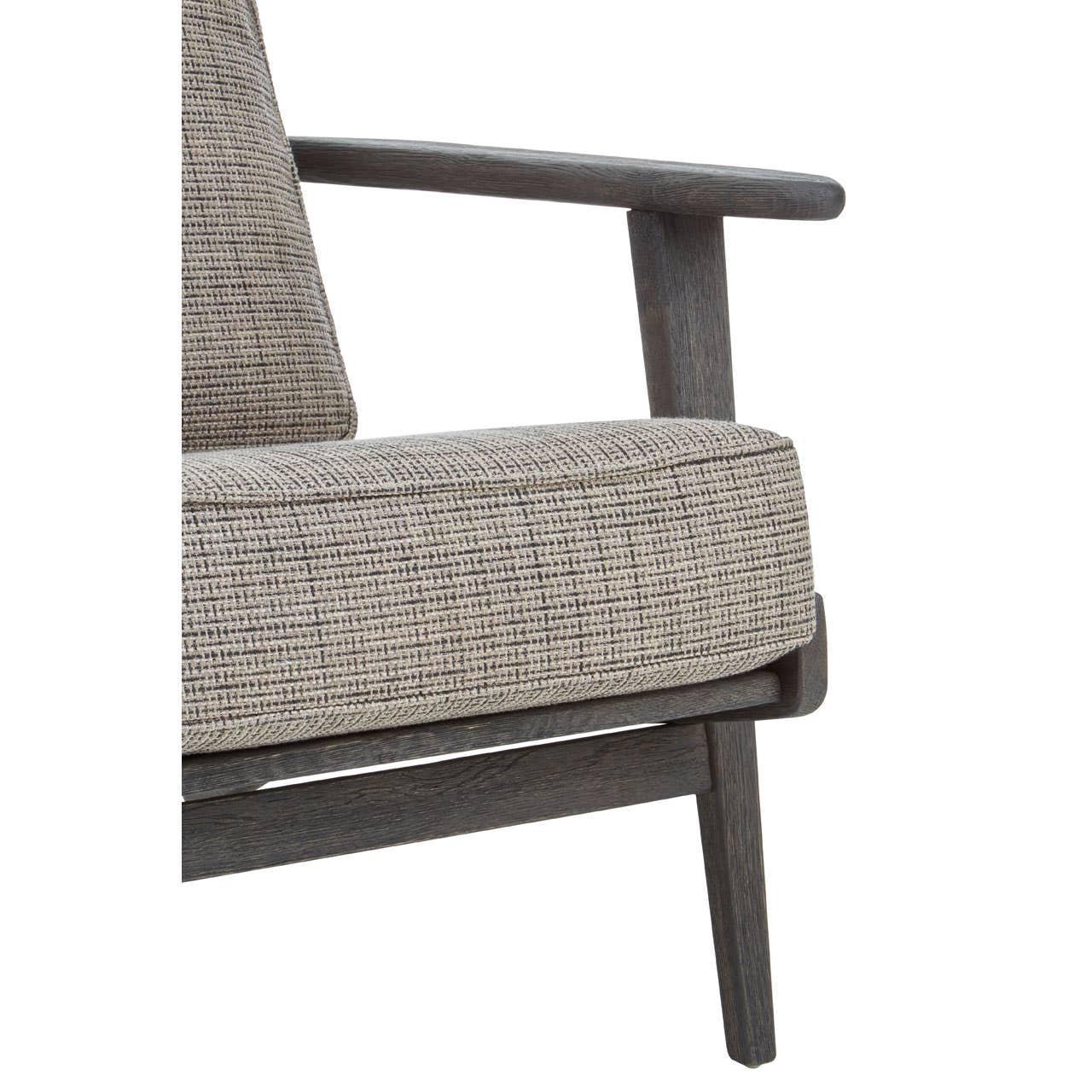 Close-up of grey fabric armchair cushion with wooden frame and armrest