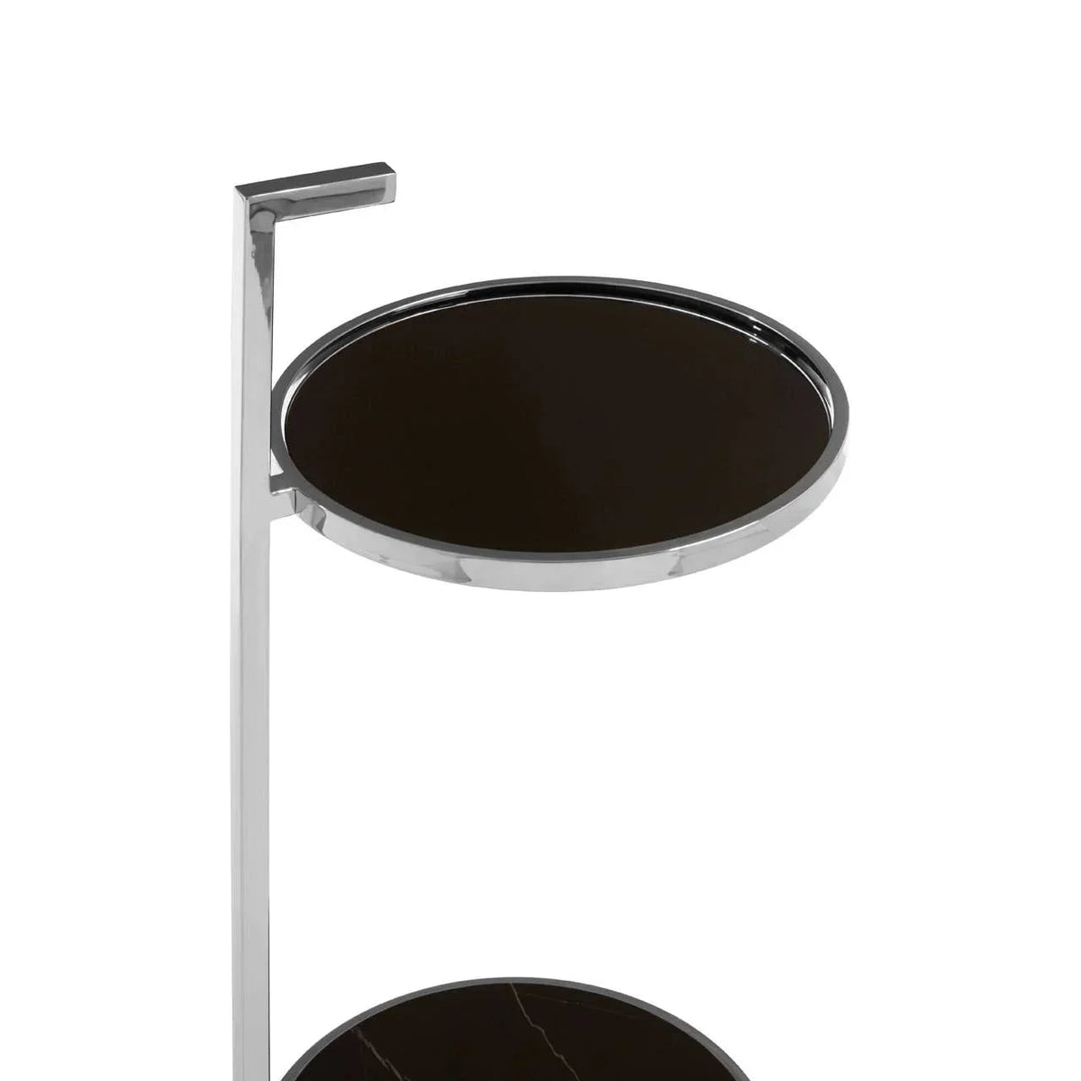 Round black glass side table with chrome frame, partial view showing two tiers