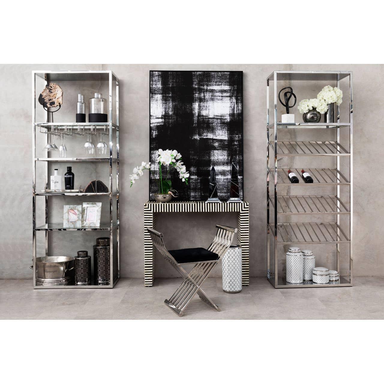 Modern chrome shelving units and striped console table with black upholstered accent chair
