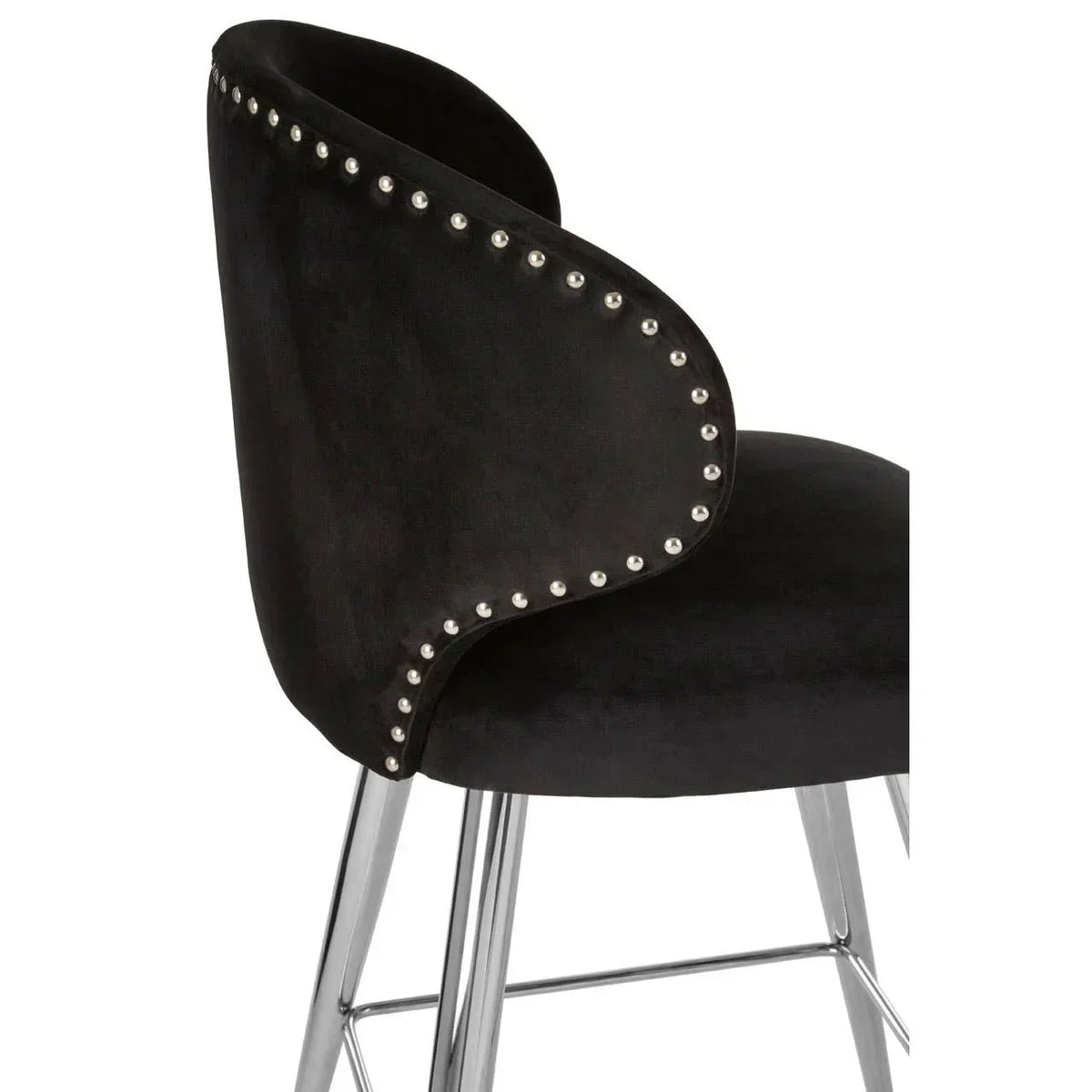 Black velvet dining chair with chrome legs and silver nailhead trim, side angle view