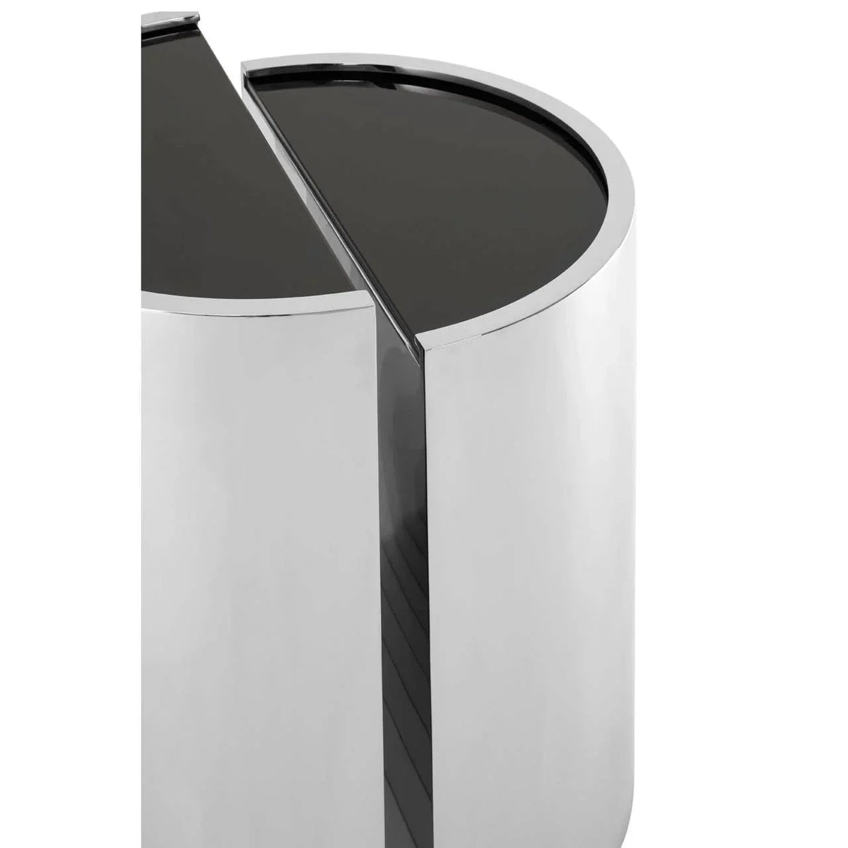 Round chrome side table with black glass top, close-up of modern geometric design