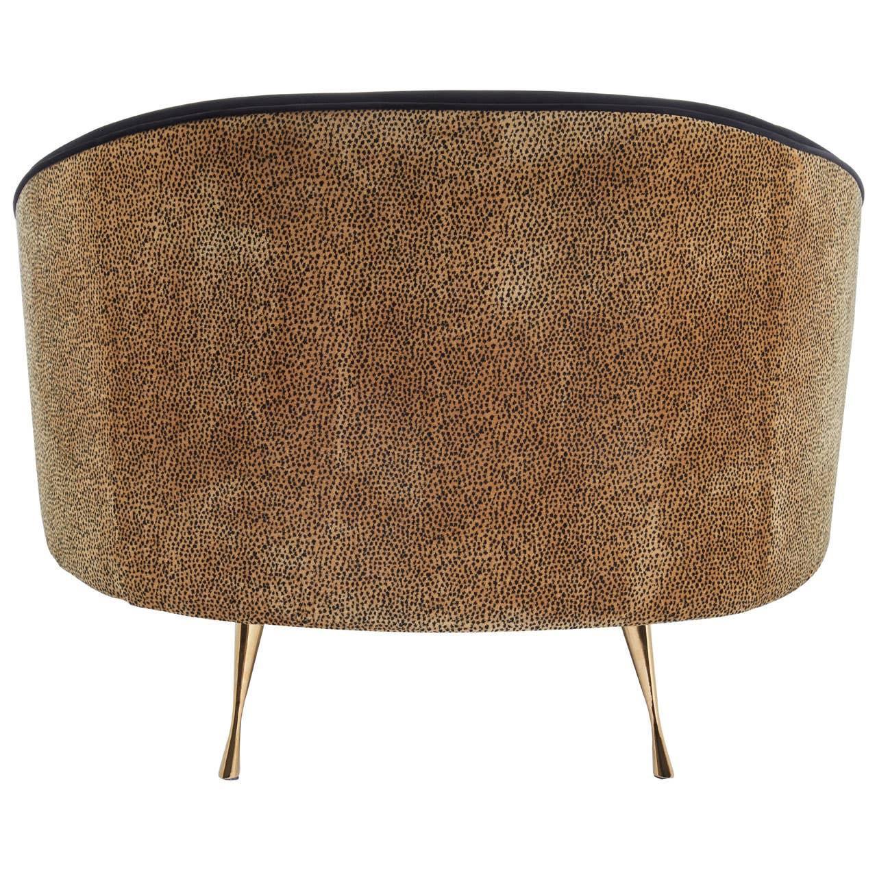 Curved sofa rear view with brown textured fabric and slim gold metal legs