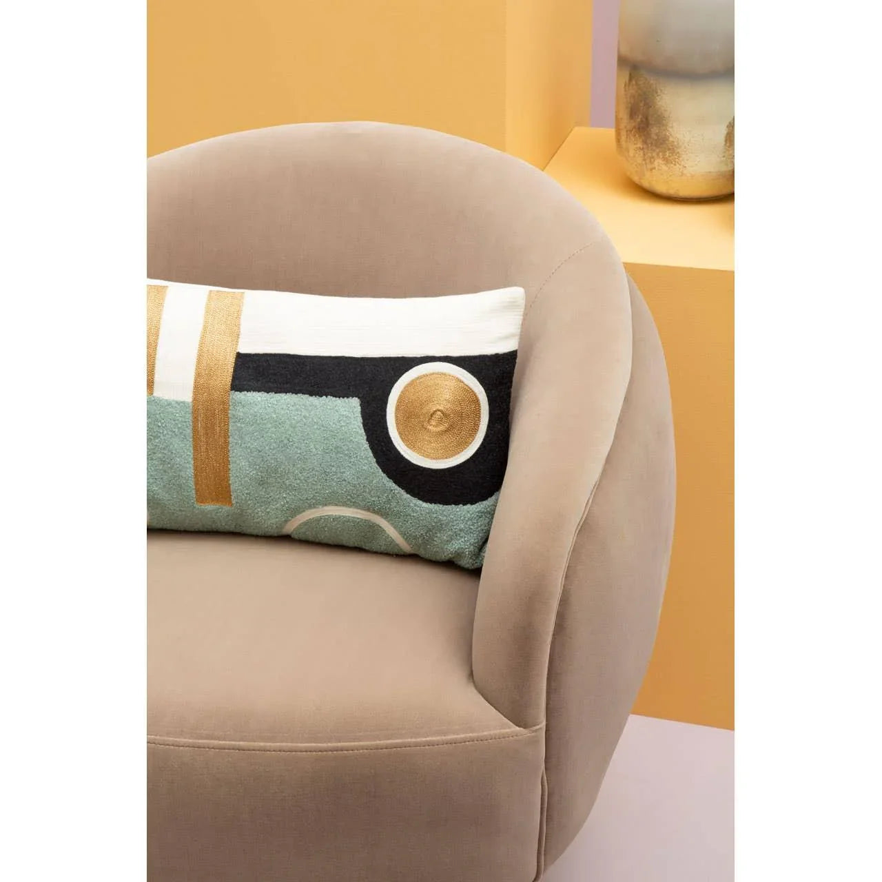 Beige fabric accent chair with modern geometric cushion and yellow background decor
