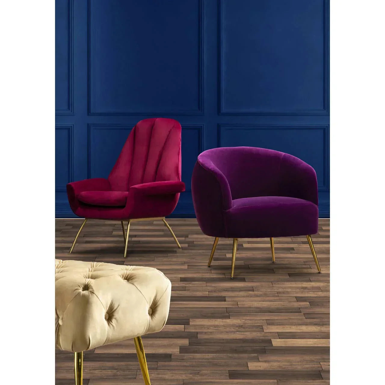 Velvet accent chairs with gold legs and a cream tufted footstool on wood flooring