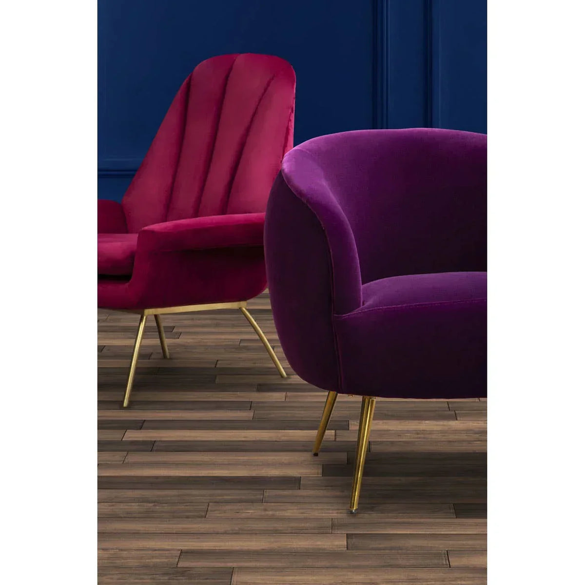 Velvet armchair and accent chair with gold legs on wooden floor against blue wall
