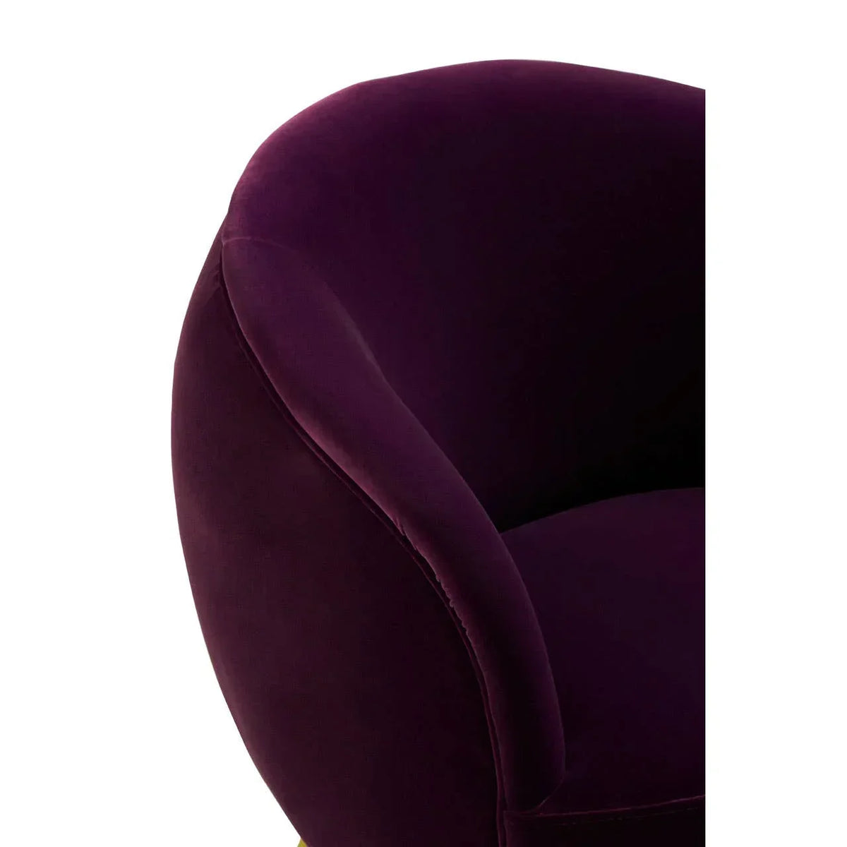 Close-up of purple velvet armchair with curved backrest and plush upholstery