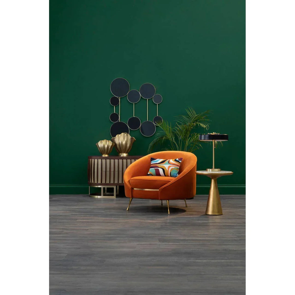 Orange accent chair with geometric cushion beside gold side table in modern living room