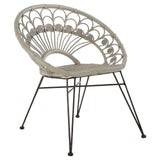 A grey natural rattan chair with a curved backrest featuring a fan-like design, supported by slender black metal legs. The seat is cushioned for comfort, and the overall style is modern and airy, suitable for indoor or outdoor use