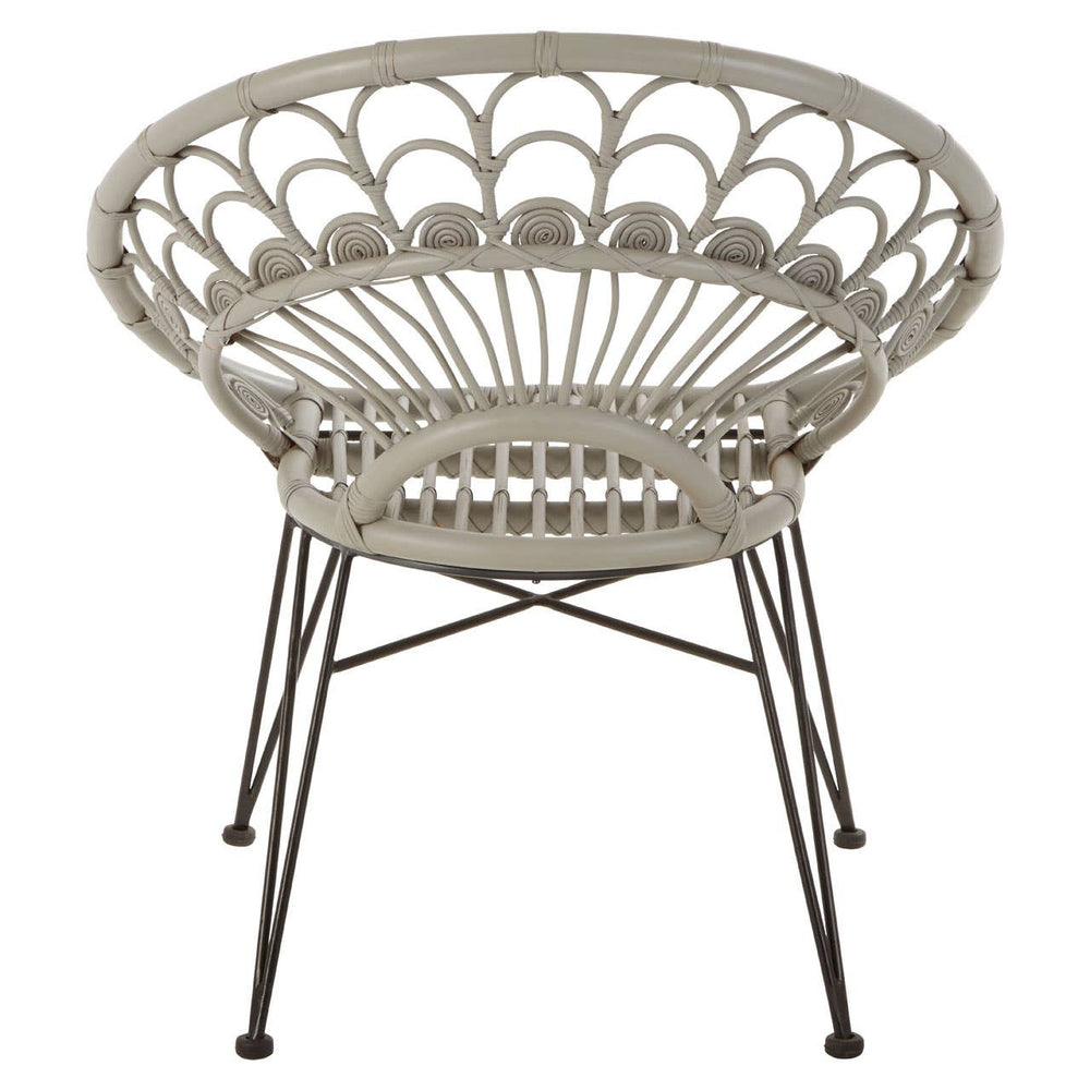 A round, grey natural rattan chair with a woven design and slender metal legs, showcasing a modern and airy aesthetic suitable for indoor or outdoor use