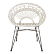 A white natural rattan chair with a circular backrest featuring a fan-like design, supported by slender black metal legs. The chair has a minimalist and modern aesthetic, suitable for various home decor styles
