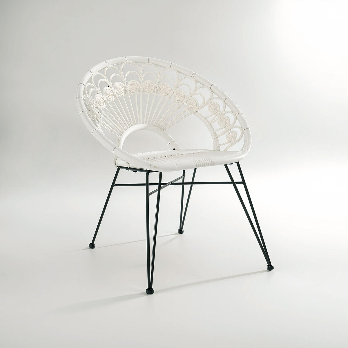 A stylish white rattan chair with a curved backrest and a natural woven texture, supported by sleek black metal legs, set against a light gray background