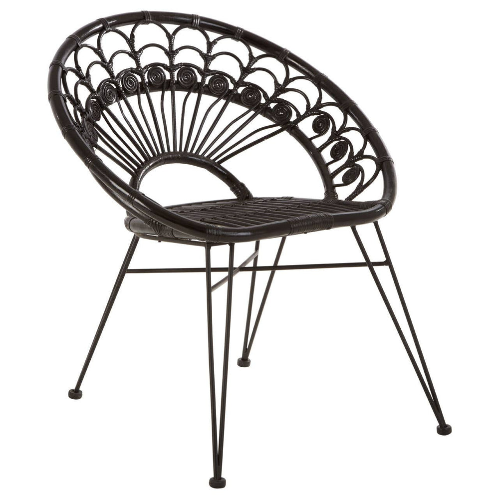 A black natural rattan chair with a curved backrest featuring a fan-like design, supported by slender metal legs. The seat is round and open, showcasing the intricate weaving of the rattan material
