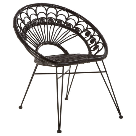 A black natural rattan chair with a curved backrest featuring a fan-like design, supported by slender metal legs. The seat is round and open, showcasing the intricate weaving of the rattan material