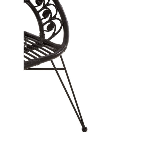 Black natural rattan chair featuring a curved backrest with intricate scrollwork and a slatted seat, supported by slender metal legs with rounded feet