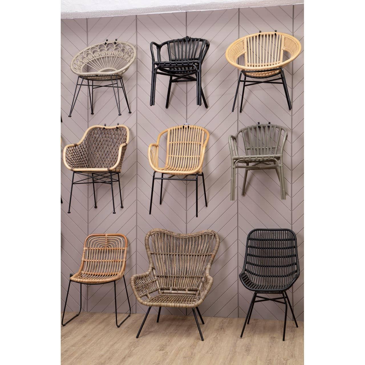 Nine rattan accent chairs with metal legs in various colors on display against chevron wall