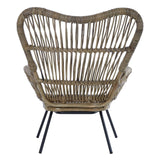 Natural rattan chair with a distinctive curved backrest and open weave design, supported by sleek black metal legs. The chair features a warm, earthy tone that complements various decor styles