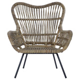 Natural rattan chair with a curved backrest and wide armrests, featuring a woven design and supported by sleek black metal legs. The chair showcases a light brown color, highlighting the texture of the rattan material