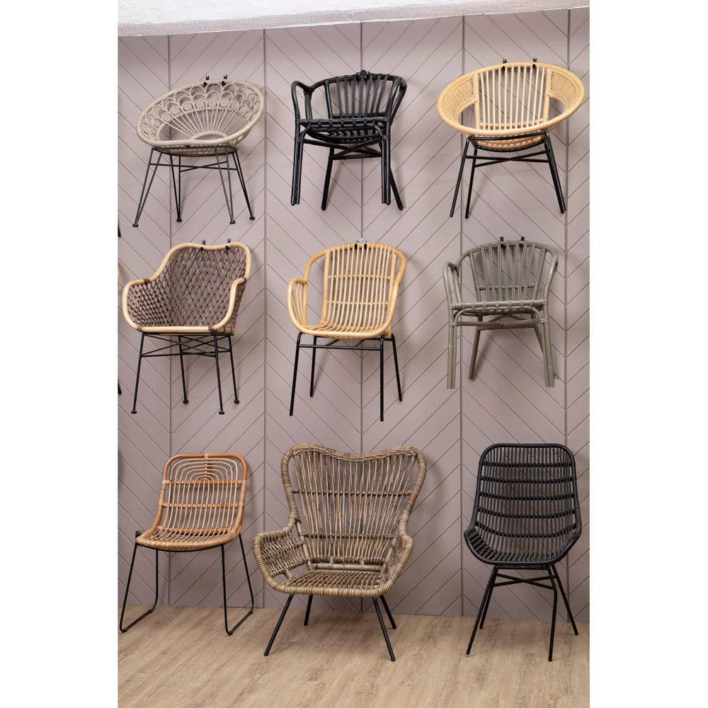 Natural rattan chairs in various styles and colors displayed on a wall, showcasing a mix of light and dark tones, with some chairs featuring curved backs and others with straight lines, all set against a neutral background