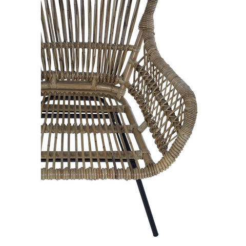 Natural rattan chair featuring a curved backrest and open weave design, supported by sleek black metal legs. The chair showcases a warm, earthy tone, highlighting the texture of the rattan material