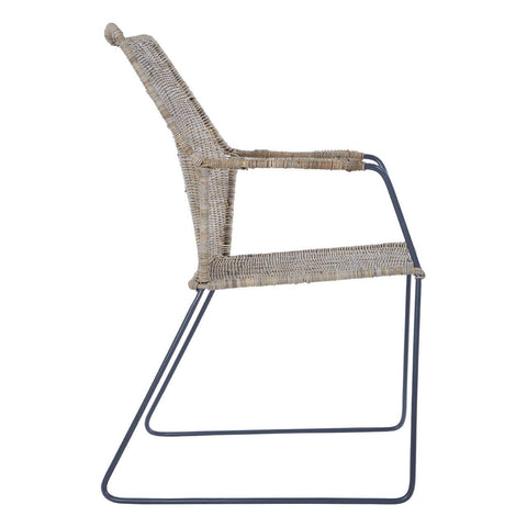 Natural rattan chair with an angled design, featuring a light beige woven seat and backrest, supported by a sleek metal frame with a minimalist style. The chair has a modern aesthetic suitable for various home decor settings