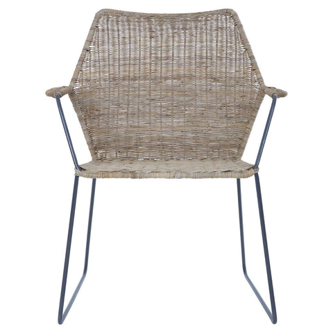 Natural rattan chair with an angled design, featuring a woven seat and backrest, supported by sleek metal legs. The chair has armrests and a light, neutral color that complements various decor styles