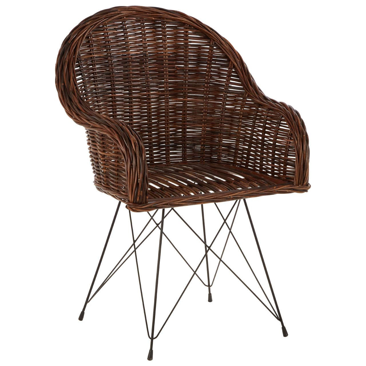 Natural rattan chair with a curved backrest and open weave design, featuring slender metal legs for support. The chair has a warm brown color, showcasing the texture of the rattan material