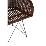 Natural croco rattan chair featuring a curved backrest and open weave design, supported by sleek metal legs. The chair showcases a rich brown color, highlighting the texture of the rattan material