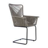 A stylish chair featuring a rattan effect design in a neutral taupe color, with a high back and armrests, supported by a sleek black metal frame. The chair has a modern, open weave pattern that adds texture and elegance to any space