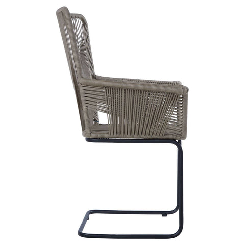Side view of the Manado Rattan Effect Chair featuring a woven rattan design in a neutral color, supported by a sleek black metal frame. The chair has a high backrest and armrests, showcasing a modern and stylish aesthetic suitable for home decor