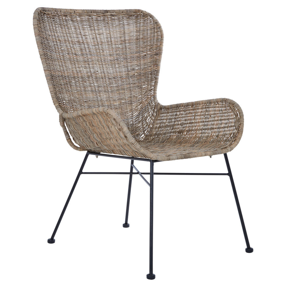 Curved design chair made of natural rattan with a light brown finish, featuring a wide backrest and armrests, supported by slender black metal legs