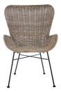 Curved backrest and armrests of a natural rattan chair with a woven texture, supported by a black metal frame and legs, showcasing a modern and stylish design suitable for home decor