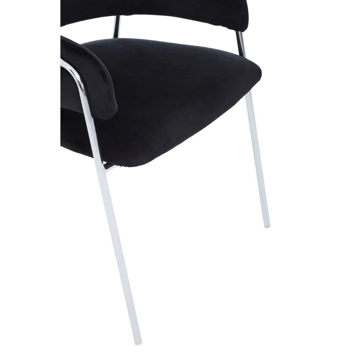 Black velvet dining chair with chrome legs, close-up of seat and armrest detail