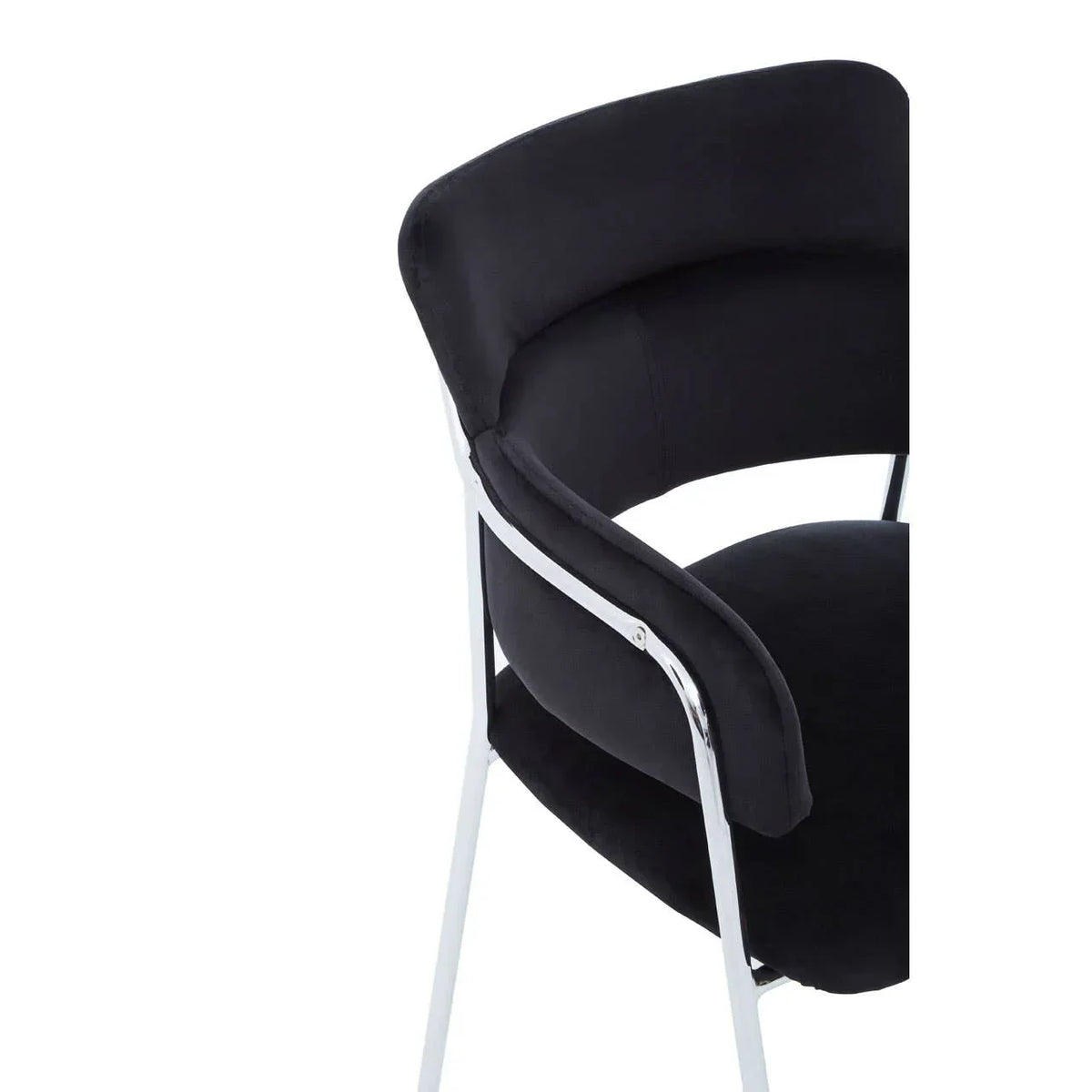 Black velvet dining chair with curved chrome legs and padded backrest, rear side view