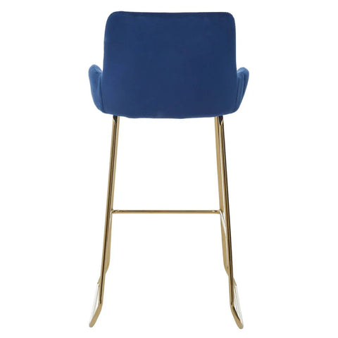 Blue velvet bar stool with gold metal legs, rear view of cushioned seat and backrest