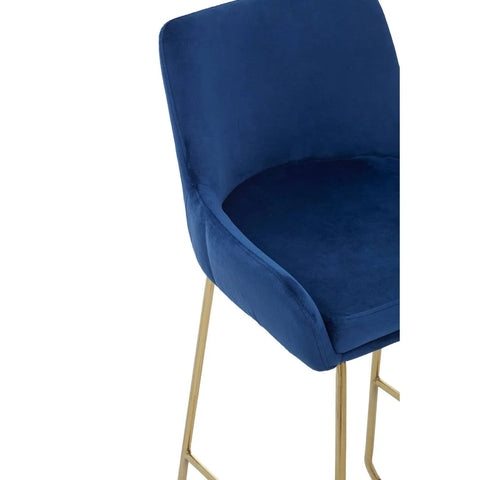 Blue velvet bar stool with gold metal legs, close-up of seat and backrest
