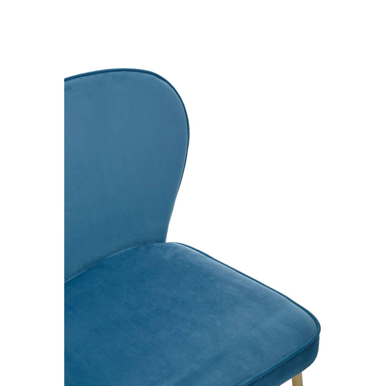 Close-up of blue velvet dining chair seat and backrest with light wood legs
