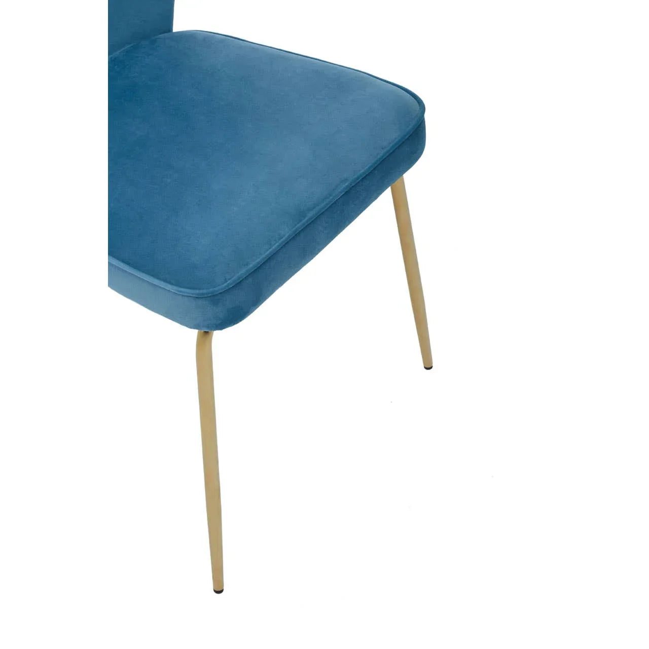 Blue velvet dining chair seat with slim gold metal legs, close-up view