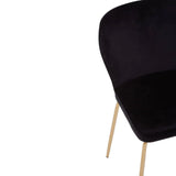 Black velvet dining chair with curved backrest and slim gold legs, angled side view