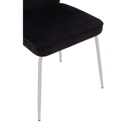 black velvet dining chair with slim white legs, side angle view