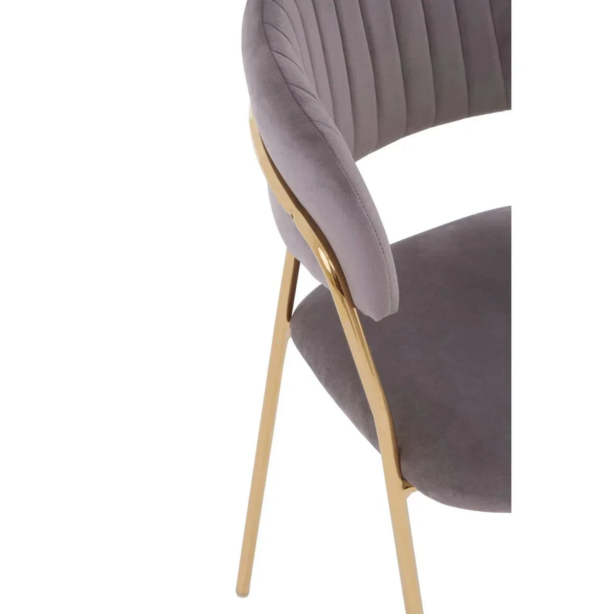 Grey velvet dining chair with gold metal legs and curved backrest detail