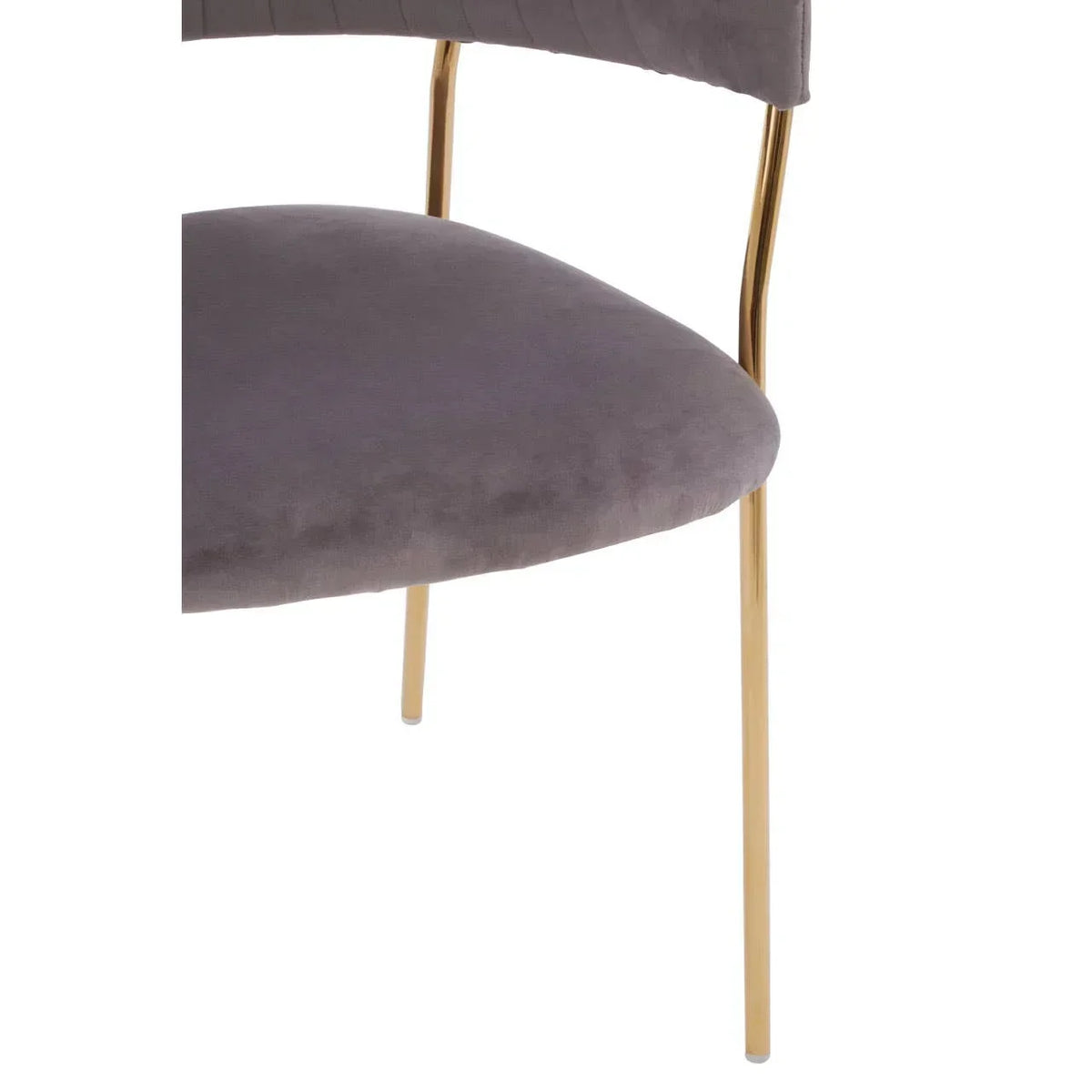Closeup of grey velvet dining chair seat with gold metal legs