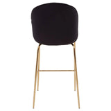 Black velvet bar stool with gold metal legs, shown from the back