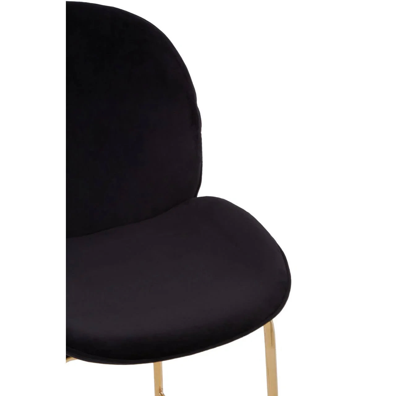 Close-up of black velvet dining chair with gold metal legs