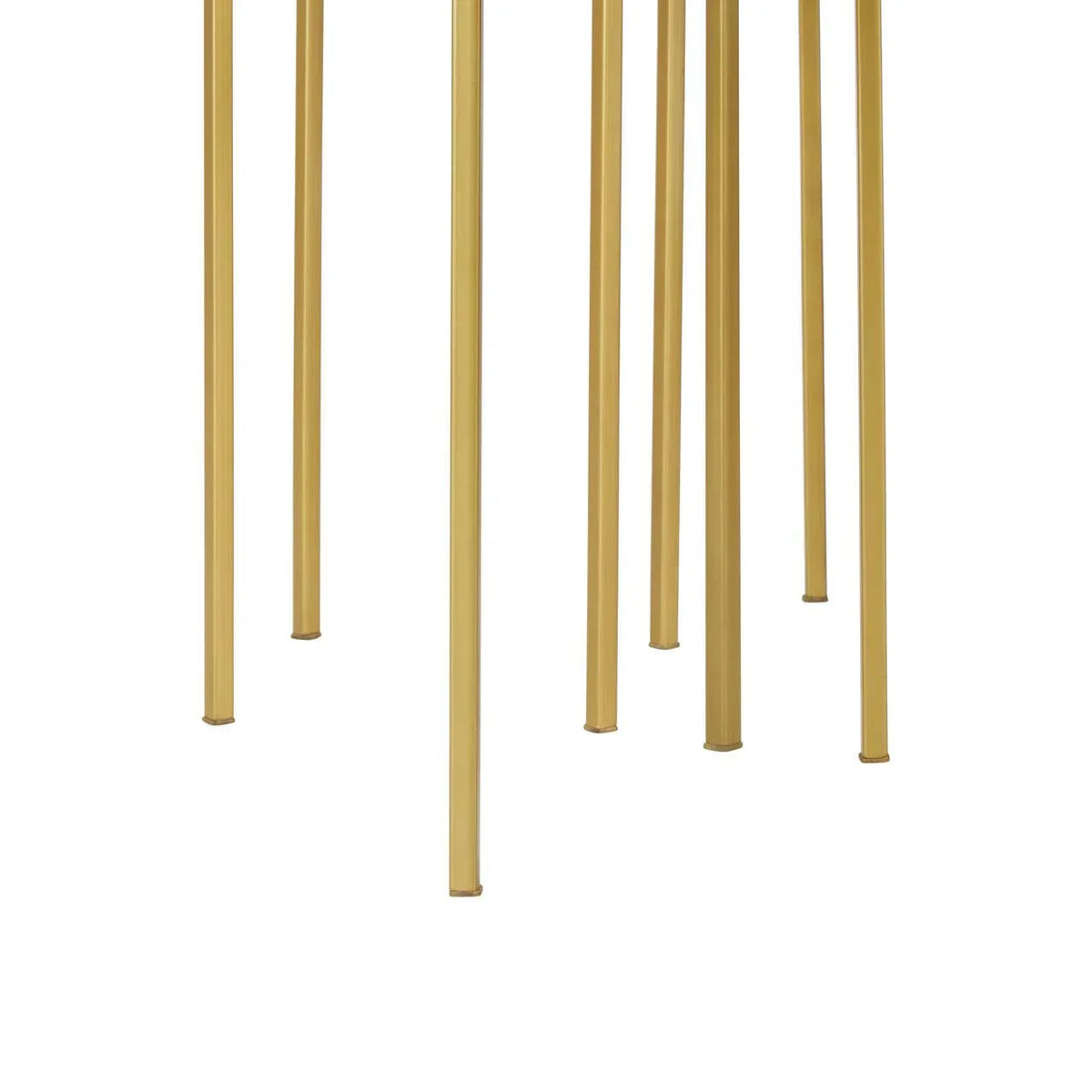 Gold metal furniture legs arranged vertically on white background