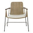 Natural rattan chair with a traditional design featuring a woven backrest and seat, complemented by a white cushion. The chair has slender metal legs and armrests, showcasing a blend of natural textures and modern aesthetics