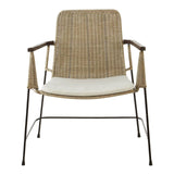 Natural rattan chair with a traditional design featuring a woven backrest and seat, complemented by a white cushion. The chair has slender metal legs and armrests, showcasing a blend of natural textures and modern aesthetics